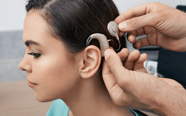 Woman getting cochlear implants put on