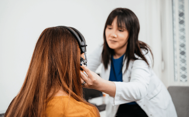 Woman performing a hearing test at her local audiologist