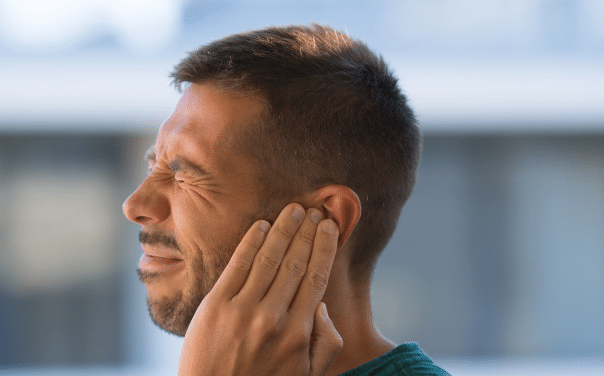 Man struggling with tinnitus symptoms